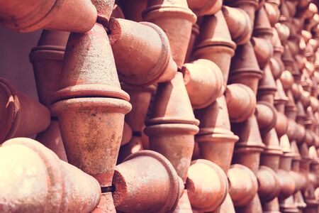 Thousands of Baked Clay Pots as a wall to decorate the garden at Nong Nooch Tropical Botanical Garden in Pattaya, Chonburi, Thailand. Selective focus, tonedのeditorial素材
