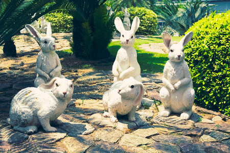 CHONBURI, THAILAND - March 18, 2016: Beautiful garden decoration in Nong Nooch Tropical Botanical Garden. A lot of white rabbits. Nong Nooch Tropical Botanical Garden is a 500-acre botanical garden in Chonburi, Thailand. Selective focus, tonedのeditorial素材