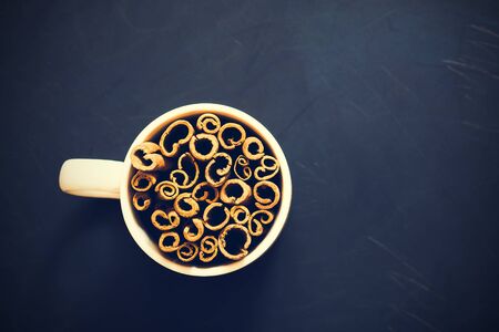 Bunch of cinnamon sticks on wooden background. Selective focus, tonedの写真素材