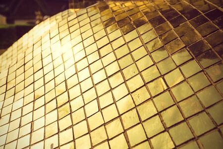 Texture of golden mosaic from a Thai temple, Bangkok, Thailand. The Grand Palace. Selective focus, tonedの写真素材