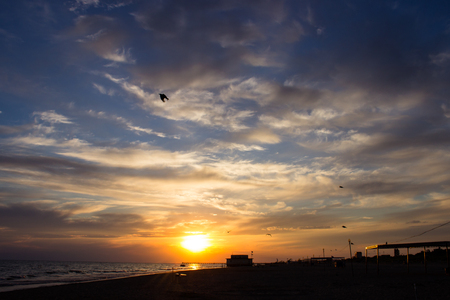 Sitting on the stone warmed up for a day at shore, it is possible to look after staggering on beauty sunset.の写真素材