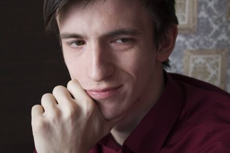 portrait of a guy, a fist propping his cheekの写真素材