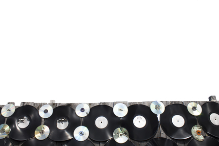 Vinyls and cd are screwed to a fence on white background, isolateの写真素材