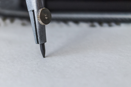 compasses draw a circle on a sheet of paper, close-upの写真素材