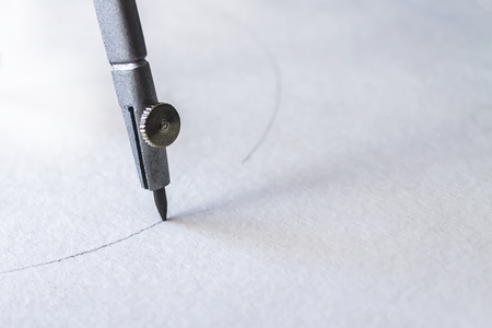 compasses draw a circle on a sheet of paper, close-upの写真素材