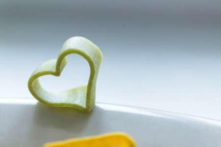 pasta in the form of hearts, different colors, before cookingの写真素材