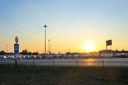 Car Parking at the airport Koltsovo in Yekaterinburg and a parked car at sunsetの写真素材