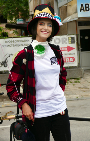 Gabrovo, Bulgaria May 19, 2018. Traditional Carnival of Humor and Satire. Street art. Woman with funny hat and makeup posing for a photo.のeditorial素材