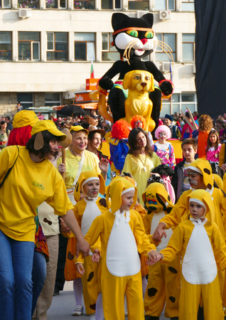 Gabrovo, Bulgaria May 19, 2018. Traditional Carnival of Humor and Satire. Street art. A group of children dressed as a yellow dog.のeditorial素材