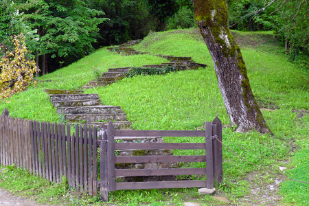 Stone stairs, meadow and fence of a farmhouse.の写真素材
