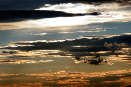 The sun is hiding behind clouds.の写真素材