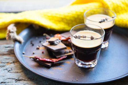 two cups of espresso coffee with chocolate and peppers on a tray, yellow scarf on the backgroundの写真素材