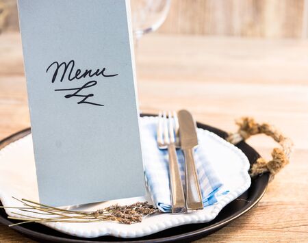 Restaurant menu on a plate with utensilsの写真素材