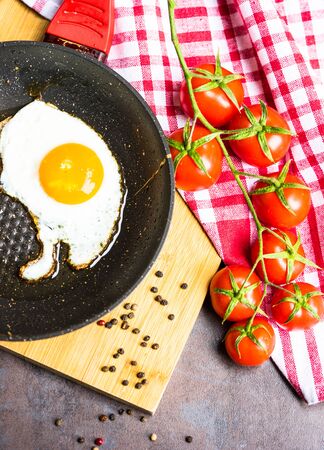 Freshly cooked breakfast with eggs, cucumber, tomato's and salad leavesの写真素材