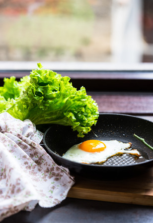 Freshly cooked breakfast with eggs, cucumber, tomato's and salad leavesの写真素材