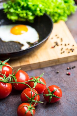 Freshly cooked breakfast with eggs, cucumber, tomato's and salad leavesの写真素材