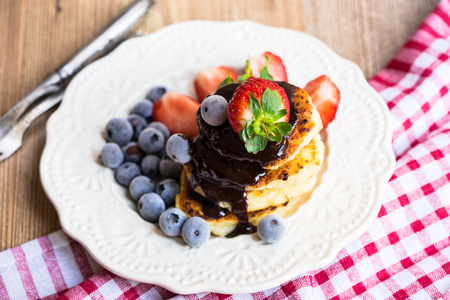 Healthy breakfast with berries chocolate and pancakesの写真素材