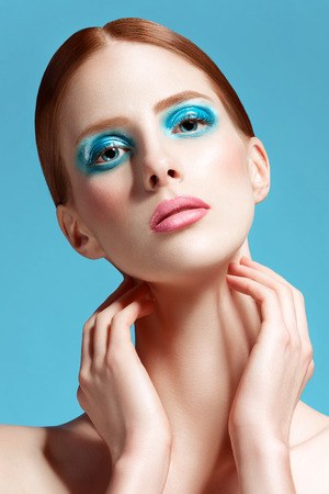 Beautiful woman close up, high-quality beauty on blue backgroundの写真素材