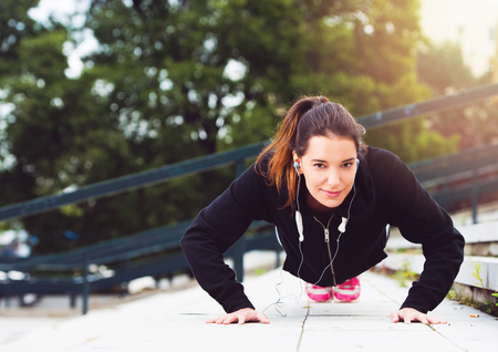 Young woman taking a break from exercising outside