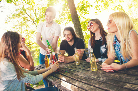 Group of young people cheering, having fun outdoorsの写真素材