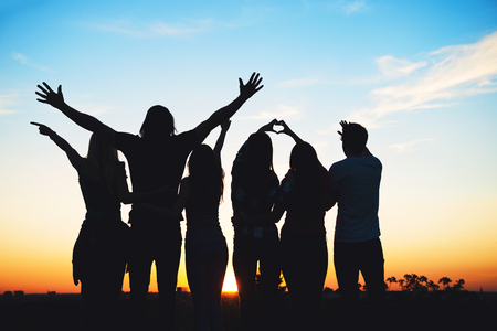 Group of people having fun outdoors; sunsetの写真素材