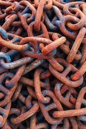 rusty corroded shackles piled upの写真素材