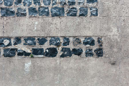 Concrete white grey wall with black bricks texture backgroundの写真素材