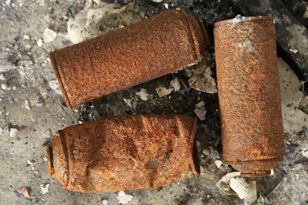 Rusty spray can burned on the floorの写真素材