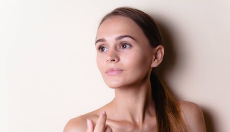 Closeup portrait of sexy white headed young woman with beautiful hazel eyes isolated on a light backgroundの写真素材