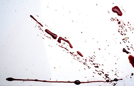 Blood on a white background. Drops and splashes of blood on a white background.