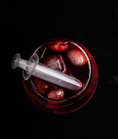 Bloody alcoholic cocktail with a syringe.の写真素材