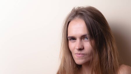 Portrait of an attractive emotional girl. On a light background with empty space.