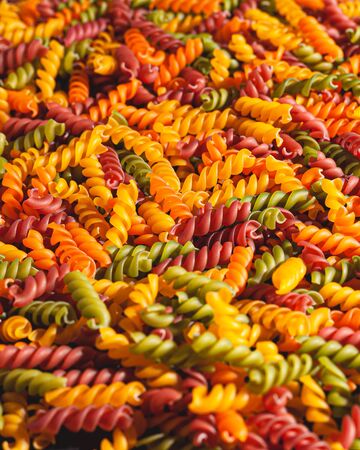 Uncooked tricolore fusilli pasta twist shapes background. Stock photo pasta twist shapes.の写真素材