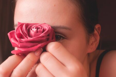 Portrait of a young girl with a rose.の写真素材