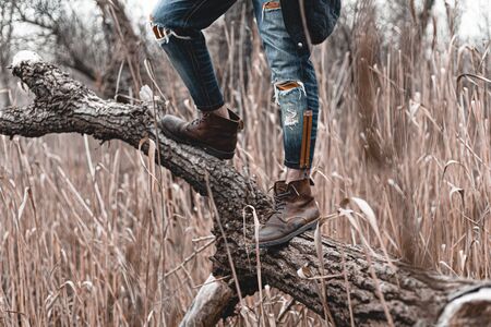Guy hiking in comfortable hiking boots. Boots close-up stock photo.