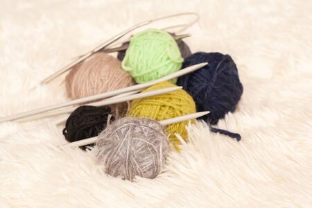 Set for knitting yarn in a ball and knitting needles. Stock photo.