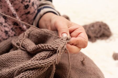 Knitting close-up. Stock photo female hands knit a sweater.の写真素材