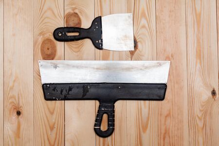 Metal spatula on a wooden background. Stock photo flat style.