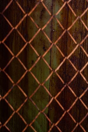 Unfocused rusty mesh texture background. Stock photo of a rusty mesh.