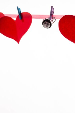 Red paper hearts on clothespins on a white background. Valentine's day and marriage proposal concept.の写真素材