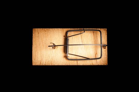 Mousetrap without bait isolate on a black background. Stock photo traps.