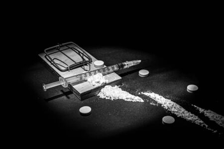 Addiction and dependence on drugs. A stock photo of a mousetrap with a bait in the form of various drugs and medicines.の写真素材