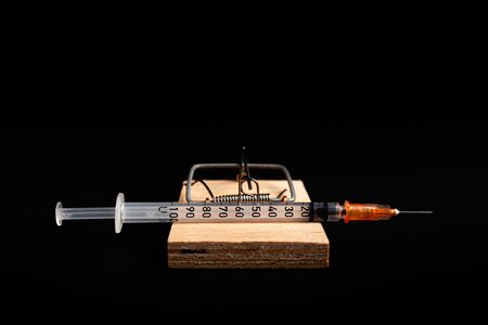 Mousetrap with a bait in the form of a syringe. Stock photo concept of addiction / diabetes.の写真素材
