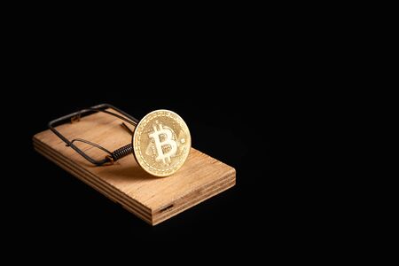 Bitcoin coin in a mousetrap isolate on a black background. Stock photo bitcoin news.の写真素材