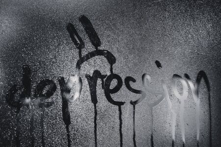 Window with raindrops. Stock photo the inscription depression in wet glass.