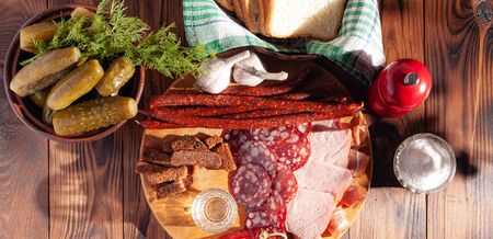 Traditional drink vodka in glasses, with a snack in the form of cold cuts and bacon, cucumbers,...