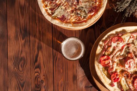 Ready-made appetizing pizza close-up. Stock photo pizza on a wooden table.の写真素材