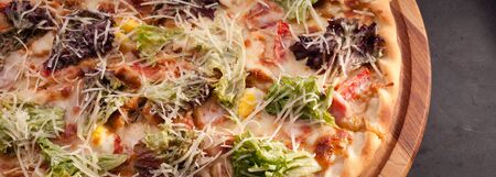 Ready-made appetizing pizza close-up. Stock photo pizza on a wooden table.の写真素材