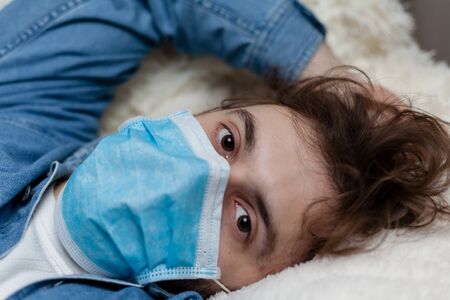Lone guy at home in quarantine. Staying at home makes you sad and crazy. Home isolation and its consequences for the psychological health of a person.の写真素材
