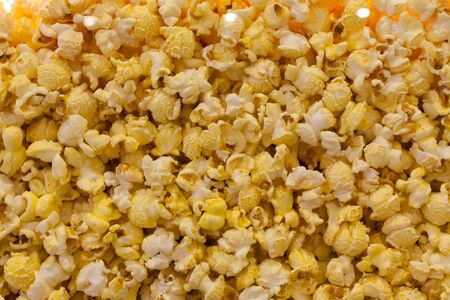 Popcorn background close-up. Assorted popcorn in a movie theater behind a glass. Texture of popcorn.の写真素材